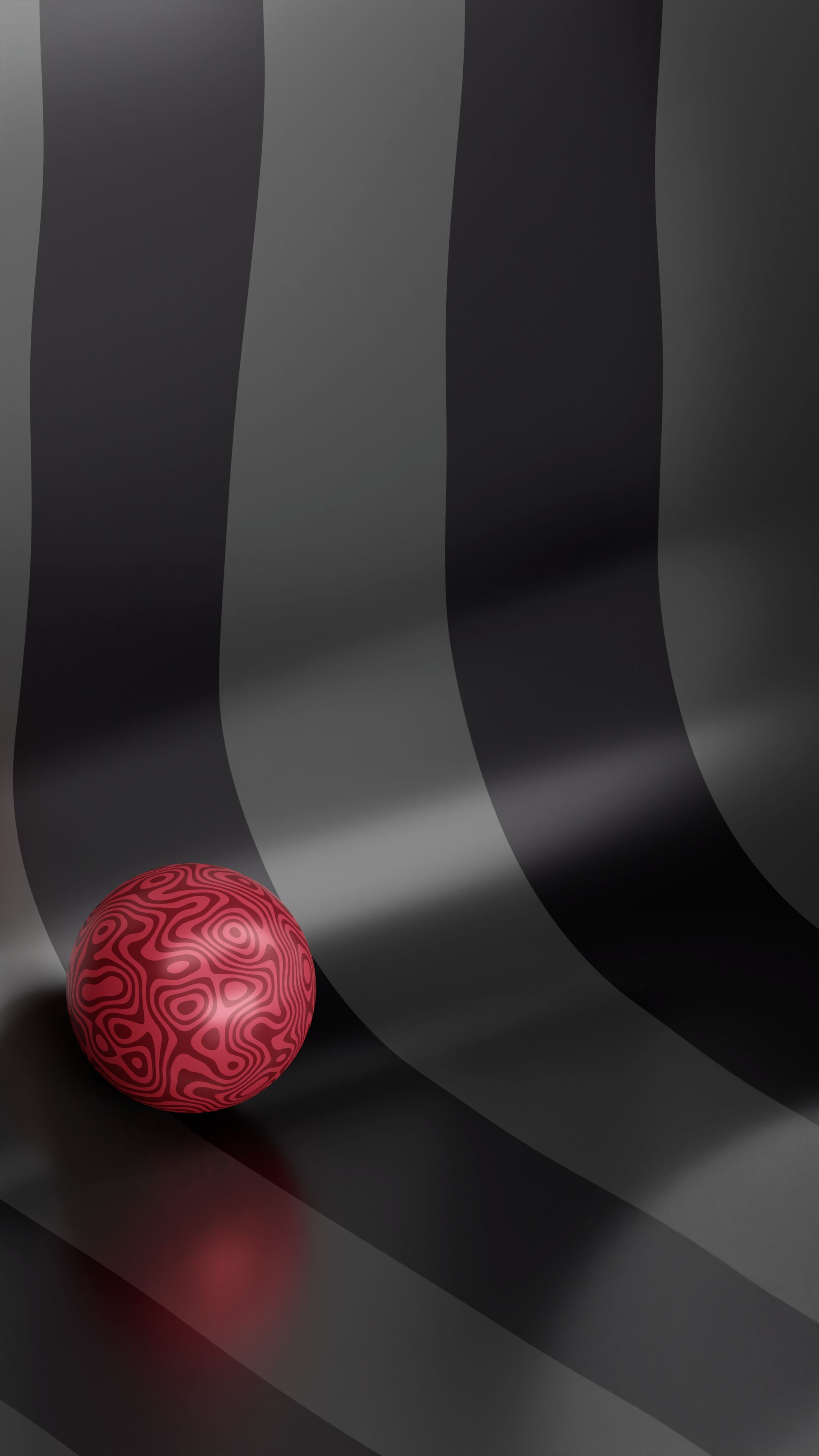 A textured red ball falling in a Grey-Black texture background.